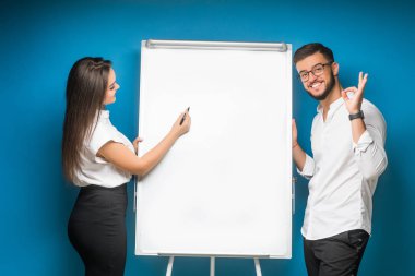 Mavi arka planda mutlu genç bir çiftin portresi