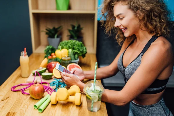 Beautiful woman with healthy green food at modern kitchen