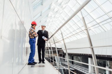 İşçi müşteriye yapılan işi gösterir! Bir işadamı inşa edilmiş çatı inşaatını inceliyor.