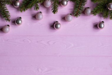Pembe ahşap arka planda Noel süsleri. Ağaç dallarının düzlüğü.