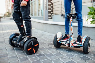 Parkta uçan kaykay kullanan iki arkadaş. Bacak fotoğrafını kapat..