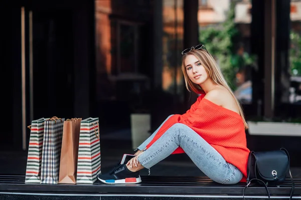 Beautiful Blonde Woman Sitting Street Surrounded Shopping Bags — стоковое фото