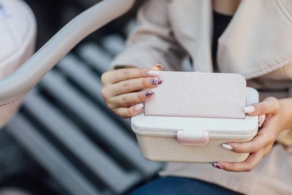 Healthy eating, storage, dieting and people concept - close up of woman with food in plastic container.