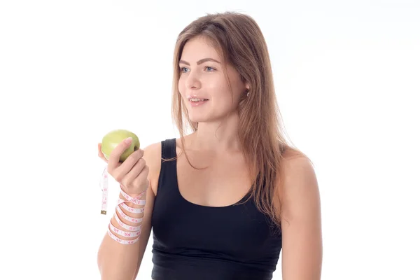 Atlética chica de pie de lado apretando una manzana en su mano —  Fotos de Stock