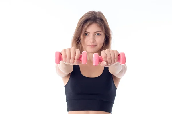 Jeune fille dans un haut de sport noir tenant haltères — Photo