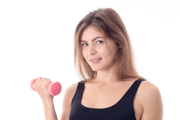 Close-up van een lachende sportieve meisje een halter houdt — Stockfoto