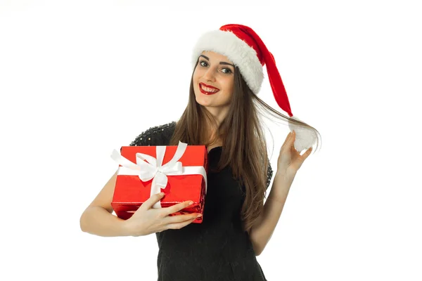 Young woman in santa hat with red gift — Stock Photo, Image