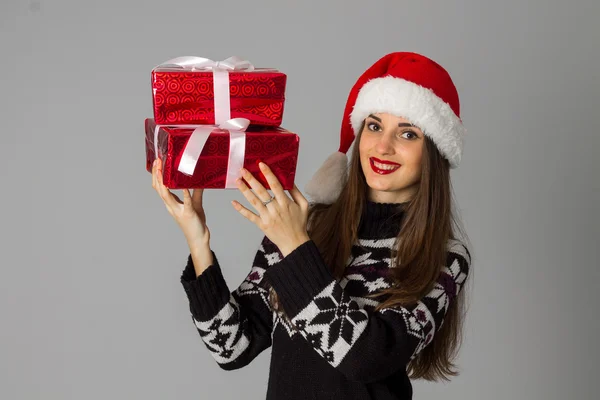 Donna in maglione caldo e cappello da Babbo Natale con regalo rosso — Foto Stock