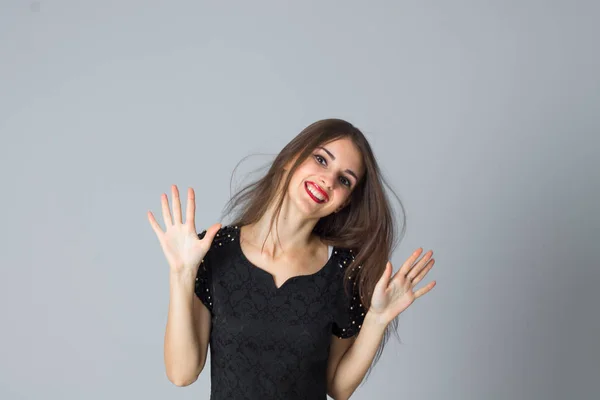 Girl in black dress posing in studio — Stock Photo, Image