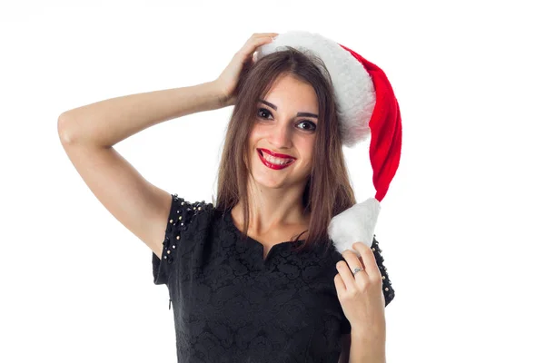Брюнетка дівчина в капелюсі Санта посміхається на камеру — стокове фото