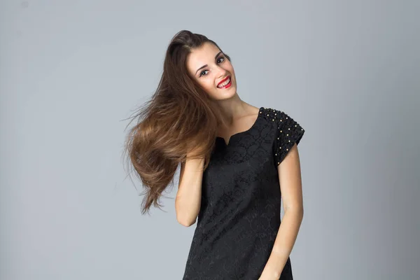 Girl in black dress posing in studio — Stock Photo, Image