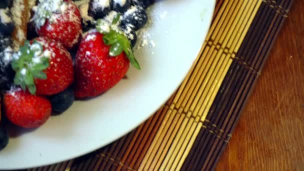 Fresh berries and croissants on the wooden table — Stock Video