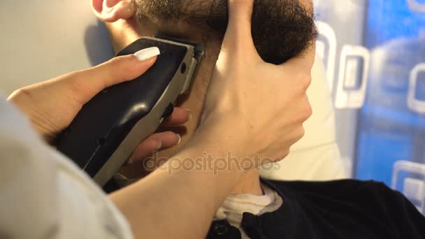 De man in de salon trim de baard met scheren machines — Stockvideo