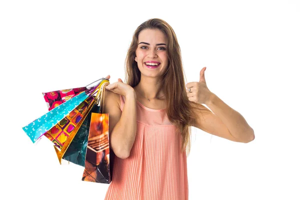 Hermosa chica sosteniendo un compras paquetes y espectáculos de clase —  Fotos de Stock