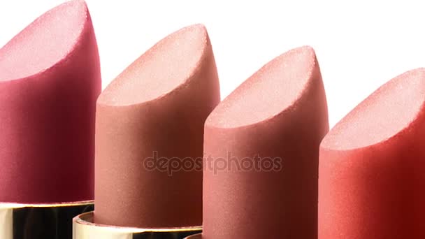 Colored lipstick color in a row on white background macro — Stock Video