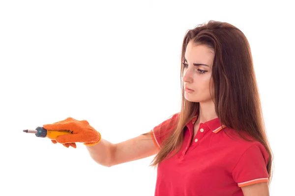 Joven encantador constructor chica en uniforme con destornillador hace renovación aislada sobre fondo blanco — Foto de Stock