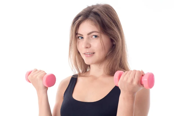 Close-up of a smiling sporty girl who holds in her hands the two dumbbells — Stock Photo, Image