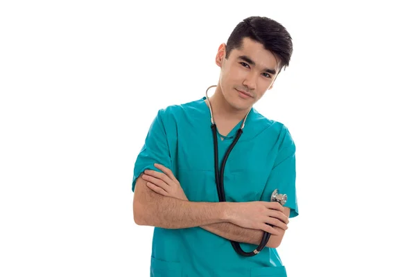 Giovane bell'uomo medico posa in uniforme blu isolato su sfondo bianco in studio — Foto Stock