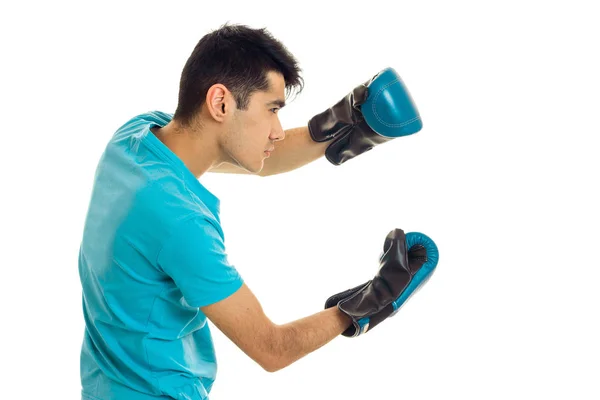 Sports man posing in blue shirt and boxing gloves isolated on white background in studio — Stock Photo, Image
