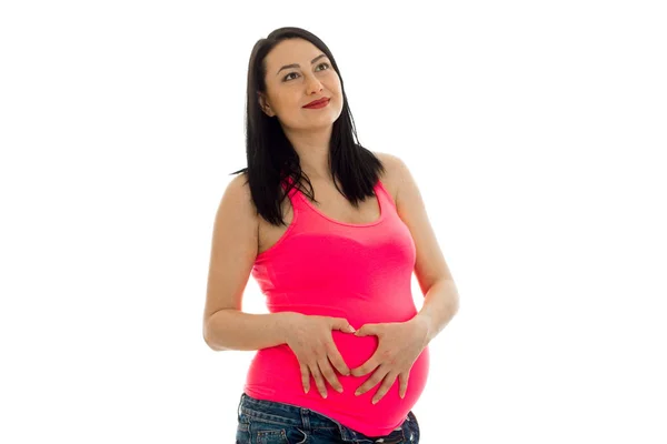 Mujer embarazada pensativa posando aislada sobre fondo blanco — Foto de Stock