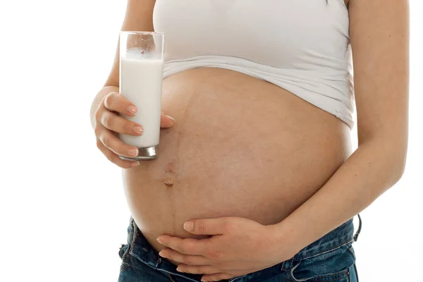Pregnant woman posing with glass of milk isolated on white background — Stock Photo, Image