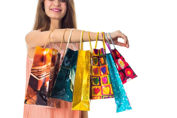 Girl have placarded on hand many bright gift packages close-up — Stock Photo, Image