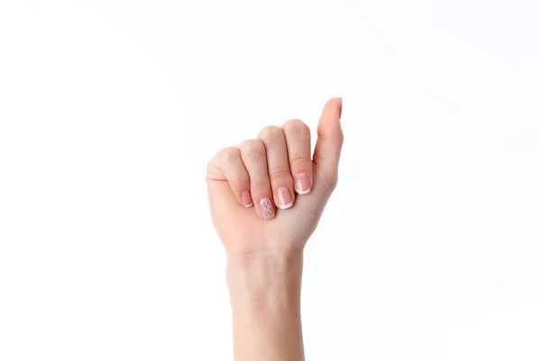 Mano femenina extendida hacia abajo con los dedos doblados aislados sobre fondo blanco — Foto de Stock