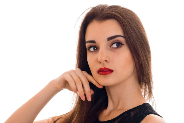 Portrait of charming young woman with red lips with her hands near face and looking away isolated on white background — Stock Photo, Image