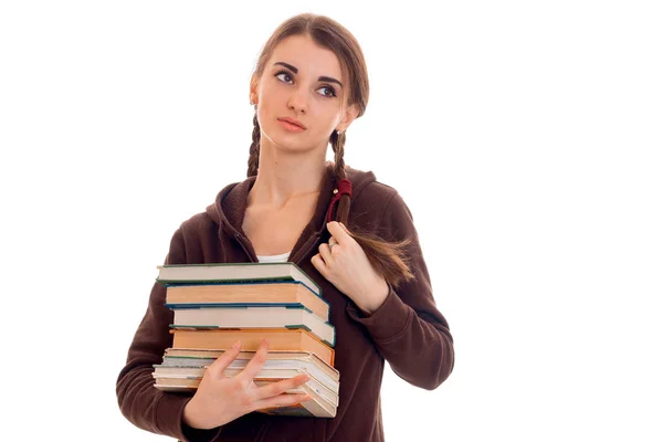 Müde junge Studentinnen mit Büchern in den Händen auf weißem Hintergrund — Stockfoto