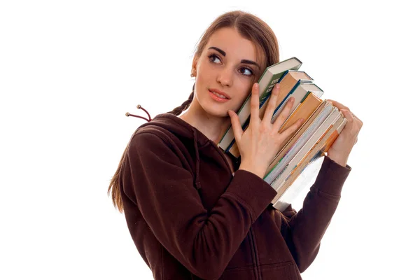 彼女の手は、白い背景で隔離の本とかなり若い学生の女の子 — ストック写真