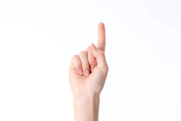 Vrouwelijke hand tonen het gebaar met verhoogde omhoog één vinger geïsoleerd op witte achtergrond — Stockfoto