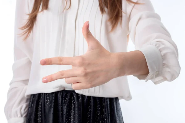 Дівчина в білій сорочці показує три пальця збільшення — стокове фото