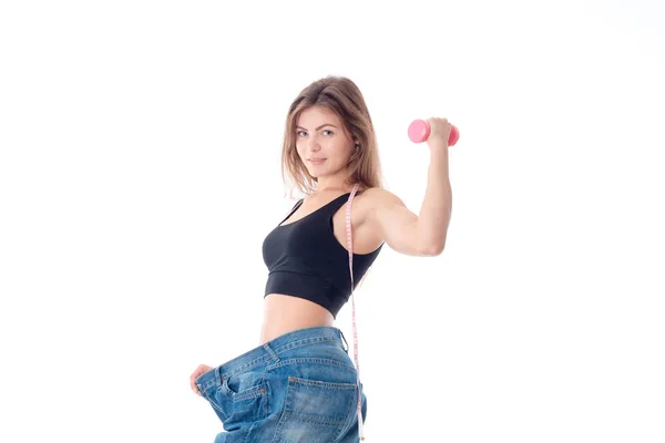 Sports girl wore slacks and shows the biceps on hand isolated  white background — Stock Photo, Image