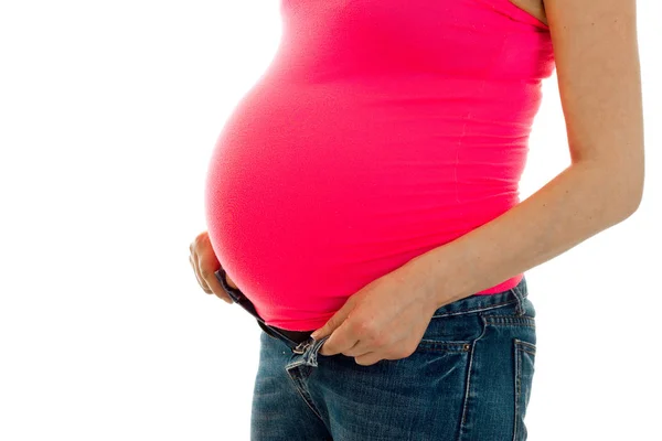 Studio portrait of pregnant woman in pink shirt isolated on white background — Stock Photo, Image