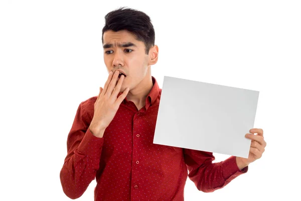 Young handsome male model in red shirt with empty placard in hands isolated on white background — Stock Photo, Image