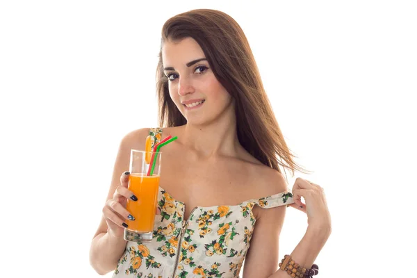 Seductive young lady with orange cocktail in hands take off her clothes and looking at the camera isolated on white background — Stock Photo, Image