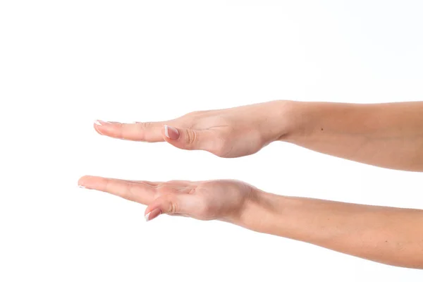 Two female hands with expanded towards each other  palms is isolated on a white background — Stock Photo, Image