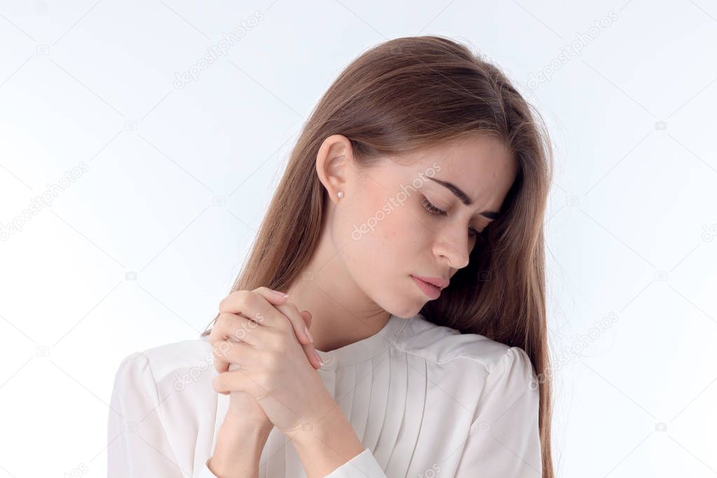brooding young girl looking down isolated on white background