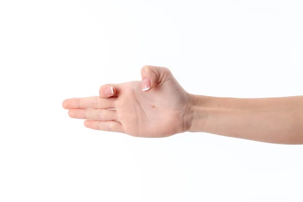 Female hand outstretched to the side and showing the gesture with a bent index finger  thumb is isolated on  white background — Stock Photo, Image