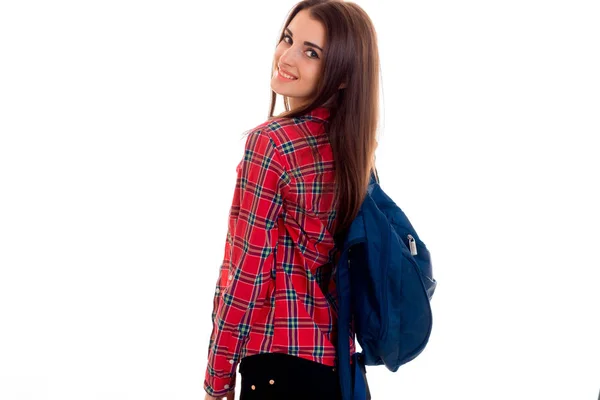 Aranyos fiatal lány egy hátizsák és egy kockás ing érdemes fordult vissza, előre — Stock Fotó