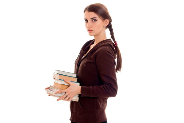 Young girl with thoughtful person stands sideways and holding books — Stock Photo, Image