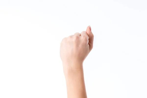 Mano femenina levantada en un puño con los dedos doblados aislados sobre fondo blanco — Foto de Stock
