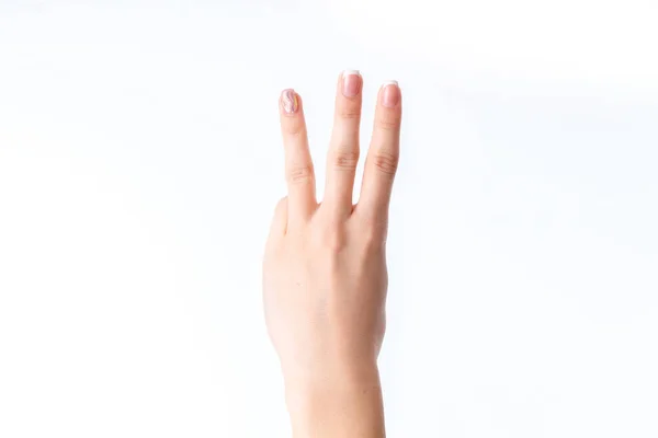 Mano femenina mostrando tres dedos aislados sobre fondo blanco — Foto de Stock