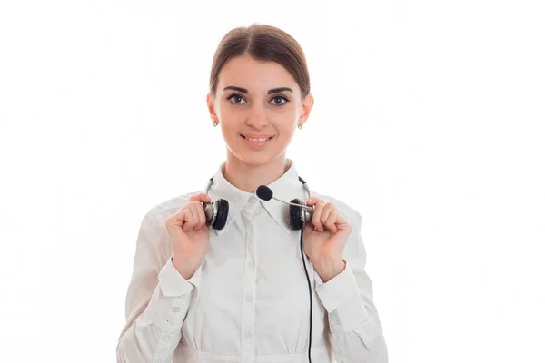 Schöne junge Mädchen lächelnd steht gerade auf und hält die Kopfhörer auf dem Nacken — Stockfoto