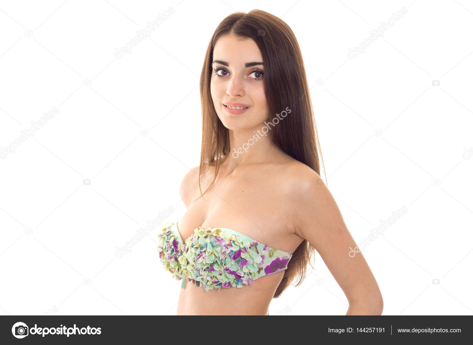Beautiful young girl in a bathing suit with big breasts looks into the  camera and smiling isolated on white background Stock Photo by  ©ponomarencko 144257191