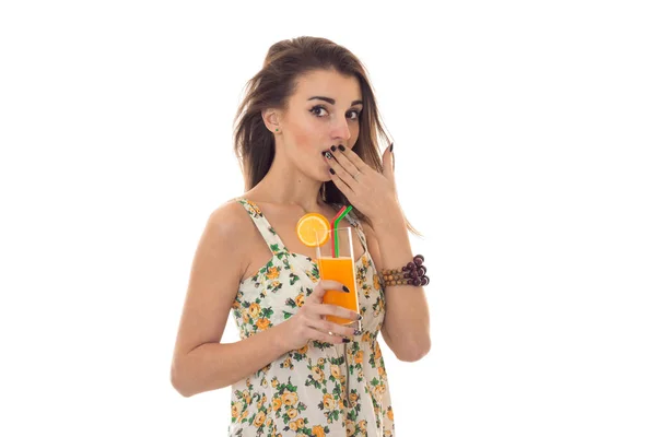 Cute young girl closes her mouth and hand holds in her hand a glass of fruit juice — Stock Photo, Image