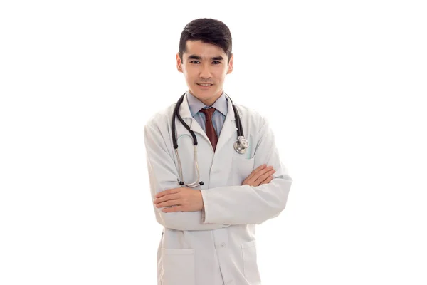 A young doctor with stethoscope and white coat looking at camera — Stock Photo, Image