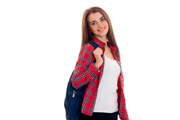 Young cute girl in a Plaid Shirt and with a Briefcase on the back looks into the camera and smiling — Stock Photo, Image