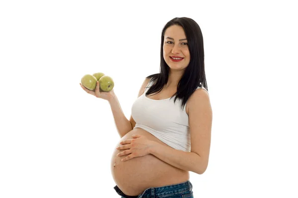 Beautiful young pregnant woman with big belly keeps Apple in hand — Stock Photo, Image