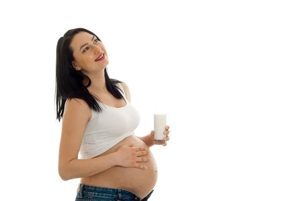 Attractive pregnant brunette girl in big belly posing isolated on white background — Stock Photo, Image